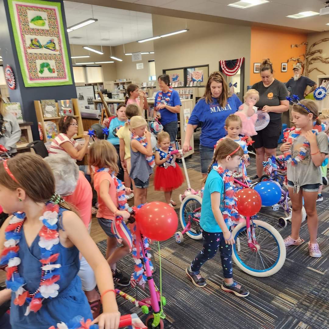 kids decorating bikes with red white and blue stuff