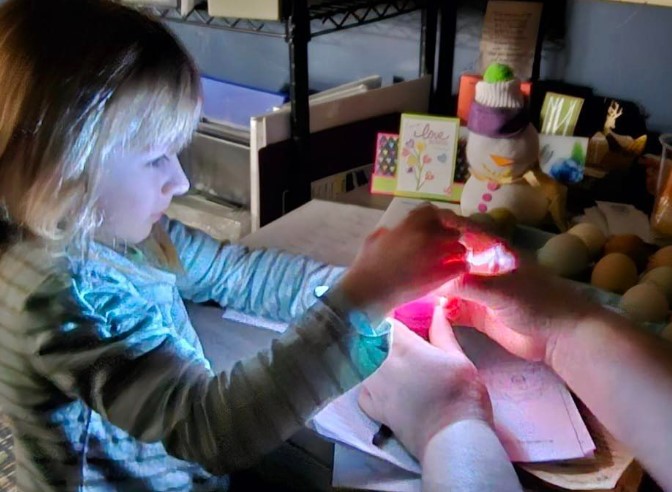 girl looking at egg