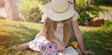 child reading in sun