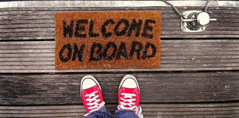 Welcome Mat next to red shoes